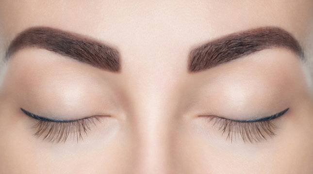 A beautiful woman with unextinguished eyelashes in a beauty salon. Eyelash extension procedure