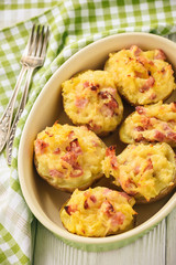 Ham and cheese jacket potatoes on dark background.