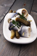 Traditional rollmops, stuffed pickled herring fillets,on a dish