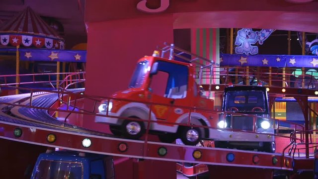 Children attraction. Little girl riding on a child train in game park in the mall center.