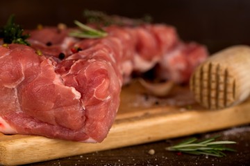 Raw meat slices on the board