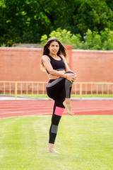 One girl wearing sportswear at the stadium.