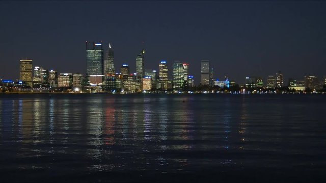 night time panning shot of the skyline of perth and the swan river, western australia