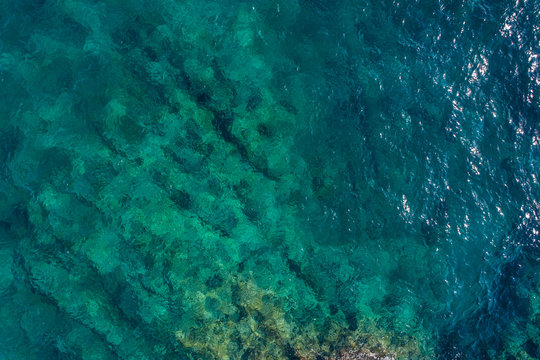 Aerial view on green waves, seabed texture