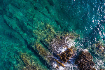 Aerial view of the green waves that beat the sea cliffs