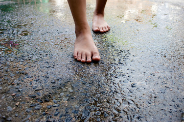 young woman walking on wet cement  floor