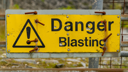 Sign: Danger Blasting, seen at Maenofferen Slate Quarry in Blaenau Ffestiniog, Gwynedd, Wales, UK
