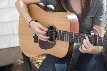 Woman's Hands Playing Guitar