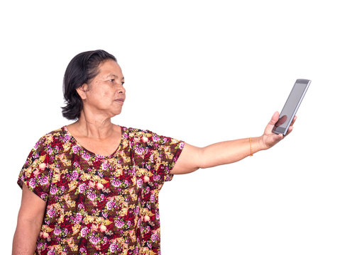 Elderly Asian Woman  Holding Digital Tablet And Stretch Out Forward To See Clearly Because Of Presbyopia