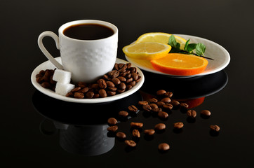 White turkish cup of coffee with sugar, orange and beans on black table