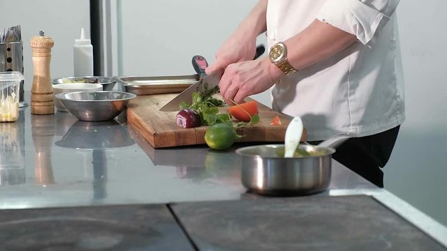 Chef cooks vegetables in a professional kitchen in a restaurant