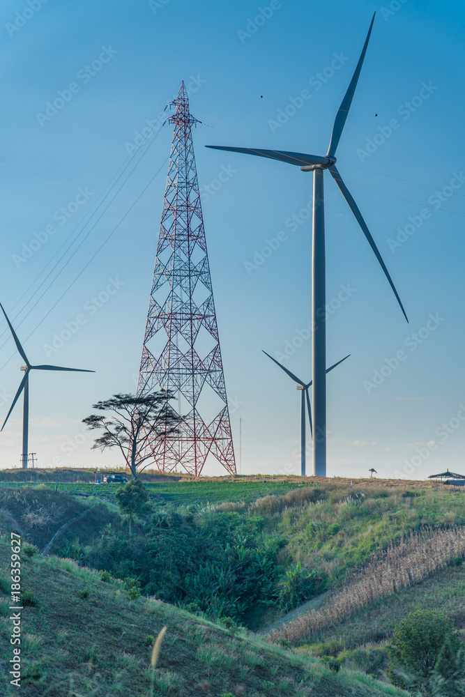 Wall mural wind turbine on hill, green energy. wind turbine wiht electric pole