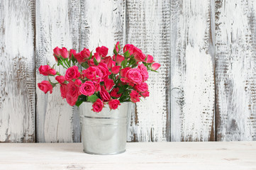 Bouquet of crimson roses in bucket