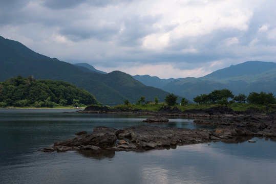Rocky volcanic shores of the Kawaguchi lake, Japan