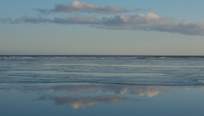 Clouds reflected in sea at low tide Iceland in winter