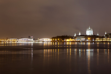 Fototapeta na wymiar Evening view of the Smolny Cathedral, Bolsheokhtinsky Bridge and the Neva River. St. Petersburg. Russia