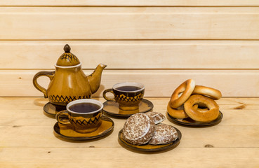 Pastry and tea-set on wooden background
