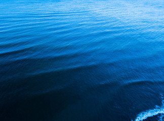 Aerial top view of blue sea surface. Nobody