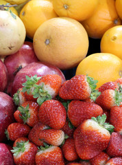 background of fresh fruit with strawberries pomegranes oranges