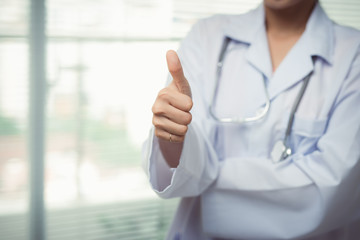 Female doctor hands with thumbs up gesture