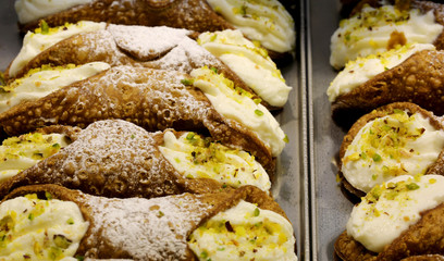 many Sicilian cannoli stuffed with ricotta and pistachios