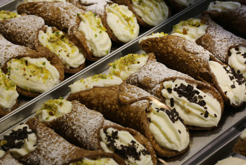 Sicilian cannoli stuffed with ricotta and pistachios or dark chocolate flakes