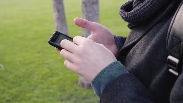 Close-Up Of Hands Using Google Maps In Smart Phone
