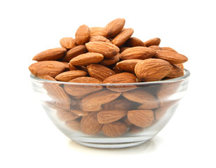 Almonds isolated in glass bowl on white background