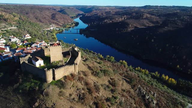Aerial view of the Belver Castle (Castelo de Belver) and village with the bridge over the Tagus River in the background, in Portugal; Concept for travel in Portugal