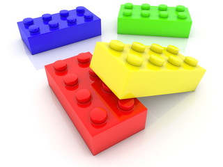 Four toy bricks in various colors