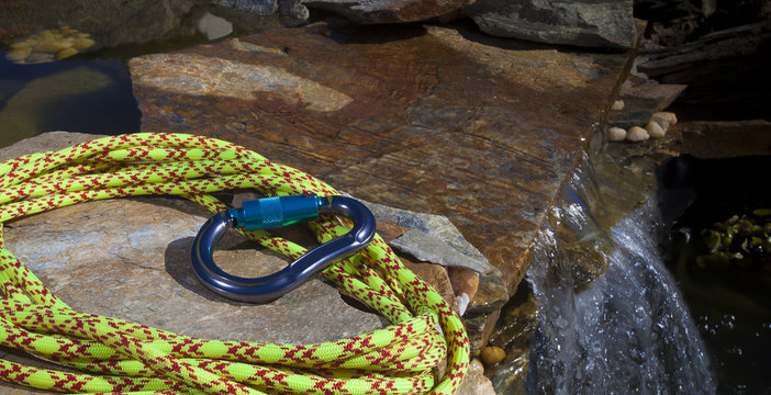 Climbing rope and carabiner next to water