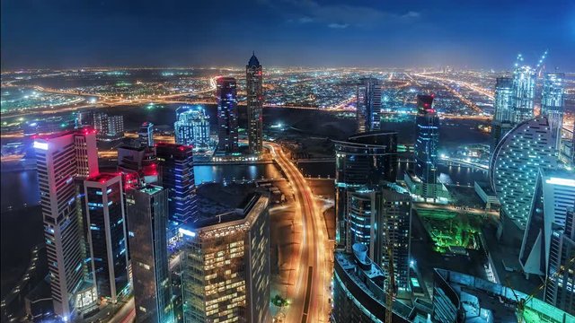 Nighttime skyline of a big modern city. Scenic aerial view of downtown Dubai, UAE with skyscrapers and highways. 4K time lapse. 
