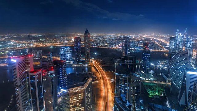 Nighttime skyline of a big modern city. Scenic aerial view of downtown Dubai, UAE with skyscrapers and highways. 4K time lapse. 