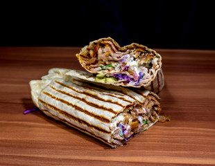 dürüm döner kebab on a wooden surface