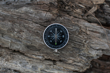 Fototapeta na wymiar Compass in the hand against mountain. Adventure end travel background.