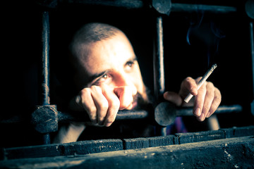 a helpless prisoner between the bars