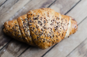 Fresh croissant on a wooden retro background. Top view
