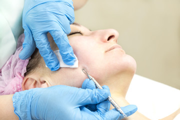 Deep cleansing of the skin on the female face with tools