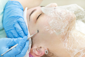 Naklejka premium Deep cleansing of the skin on the female face with tools