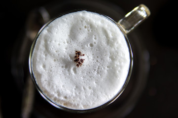 Top view of hot coffee cappuccino cup with milk foam
