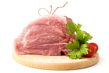 Fresh raw meat with parsley leaves and tomatoes.