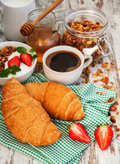 Croissant, coffee, granola  and strawberry