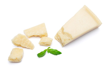 pieces of Parmesan cheese with basil on white background
