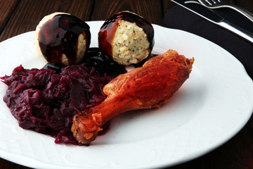Crusty Christmas goose leg with braised red cabbage and dumplings