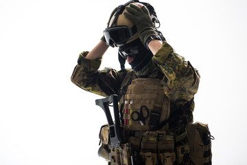 Orderly soldier speaking by appliance while putting helmet on. Army concept. Isolated and copy space