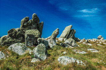 granite rocks stand out against a blue sky on the island Ouessant in Brittany, France