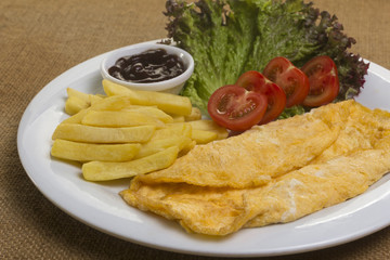 Omelet with Fried Potatoes, Tomateos and Barbecue Sauce on a White Plate Bird's Eye View