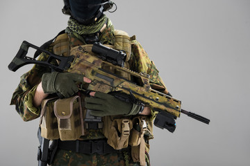 Close up male hands keeping assault carbine. Danger and military concept. Isolated