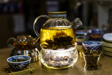 Blooming Flower Tea in Glass Tea Pot with traditional chinese accessories. Teashop