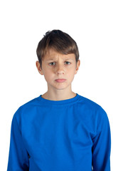 Sad young boy in blue pullover is upset on white background